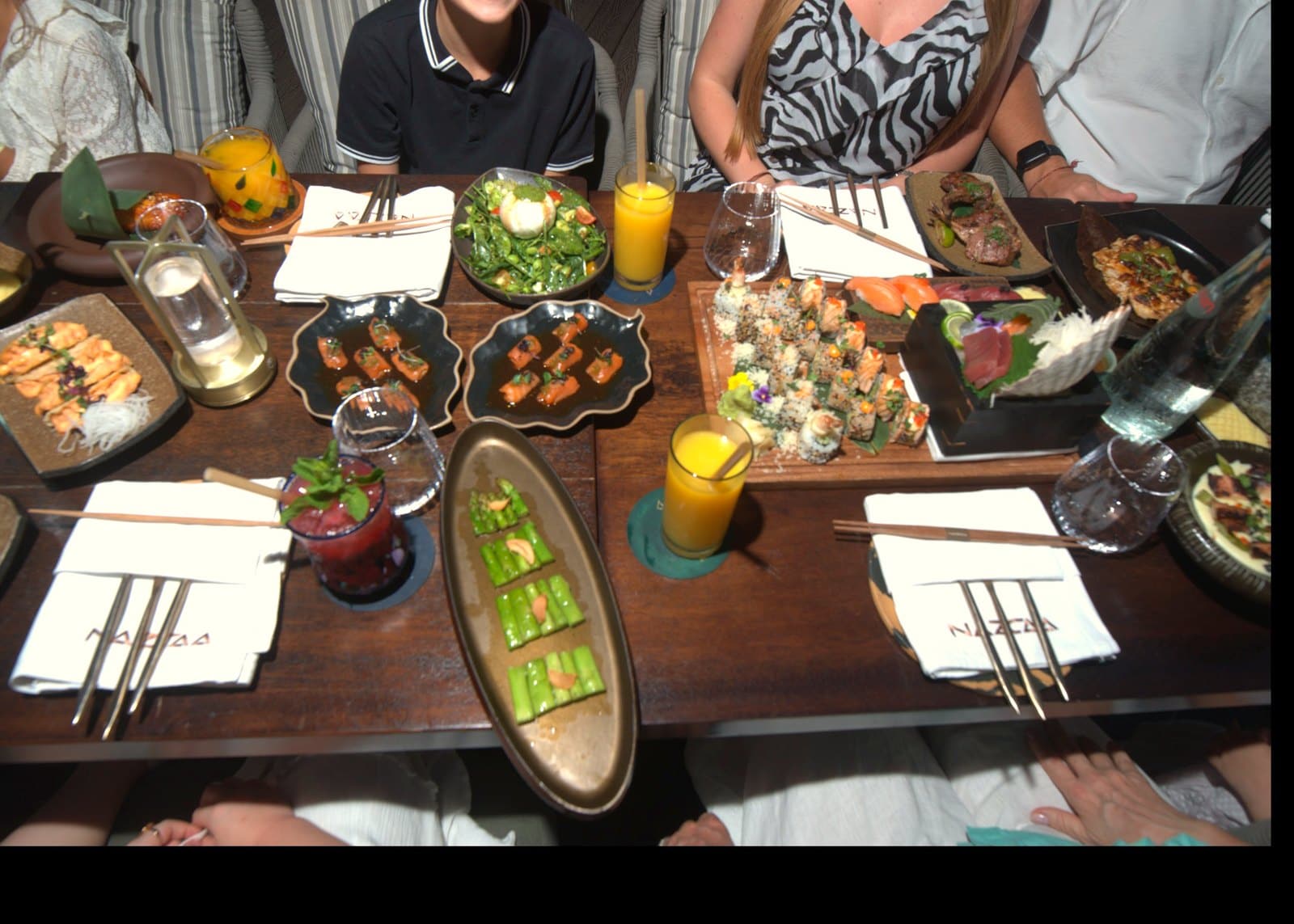 A family table at Flamingo Brunch set with Nikkei sharing plates, maki and fresh juices