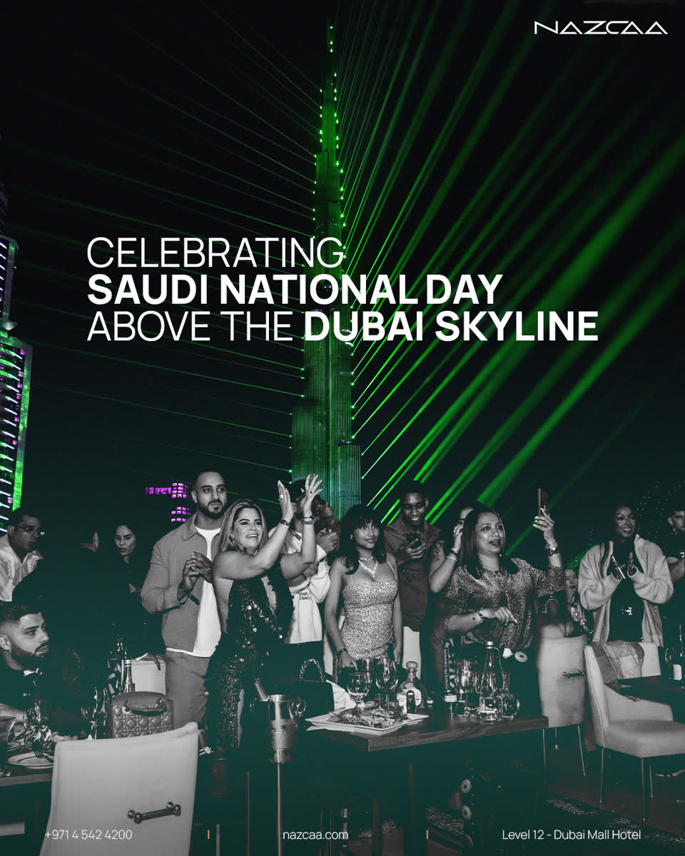 Celebrating Saudi National Day above the Dubai skyline at NAZCAA, with the Burj Khalifa lit in green